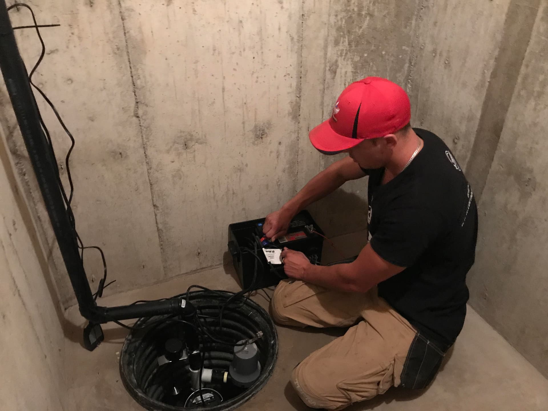 Battery backup sump pump unit installed beside a primary pump in a Toronto basement — Tornado Plumbing & Drains.