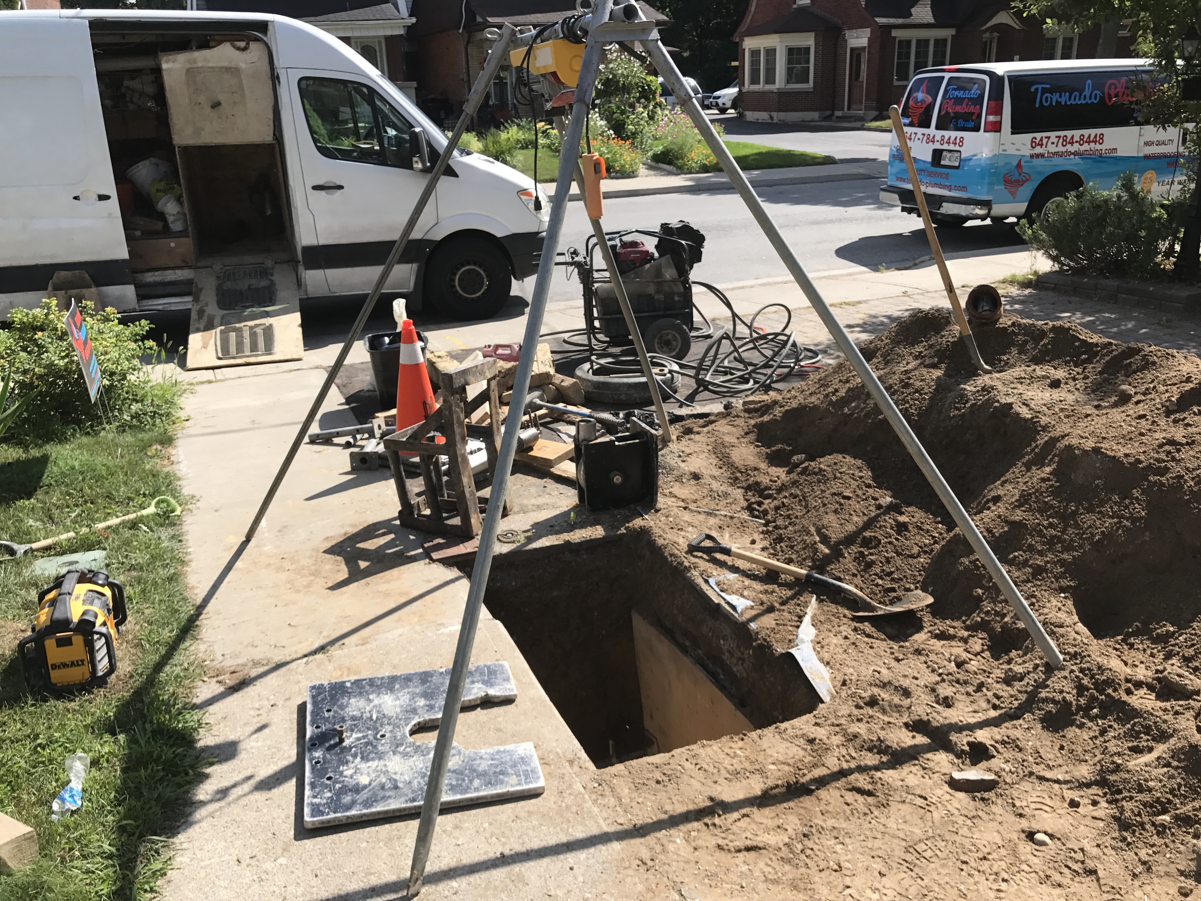 Excavation setup on a residential driveway before underground line work begins