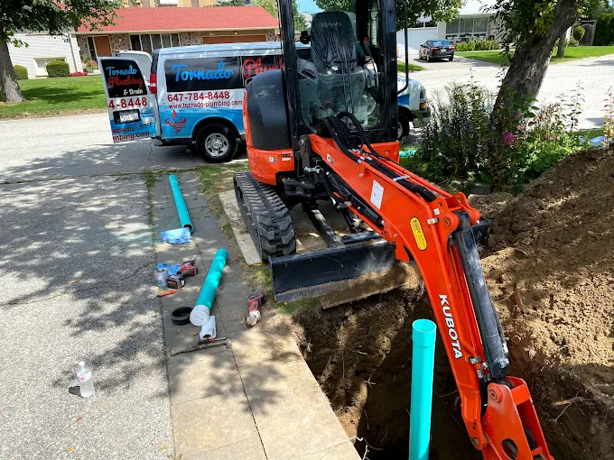 Excavation trench with teal underground water service line during residential replacement work