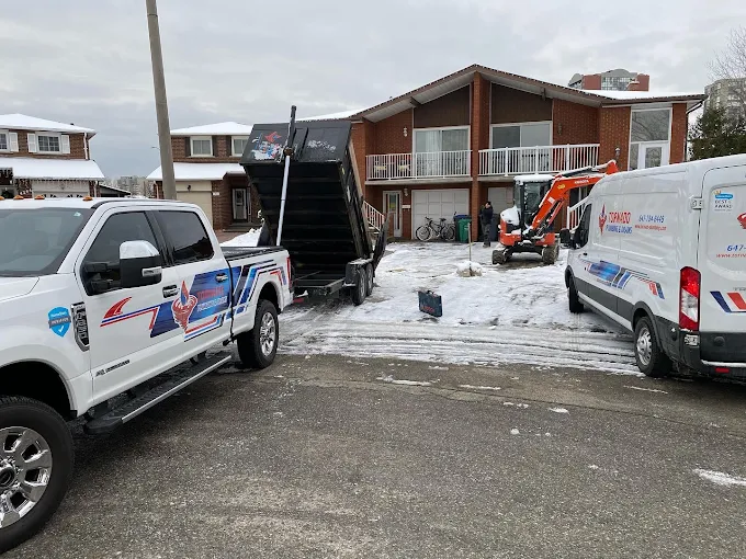 Tornado Plumbing trucks and excavation equipment staged at a winter emergency plumbing job site in Toronto