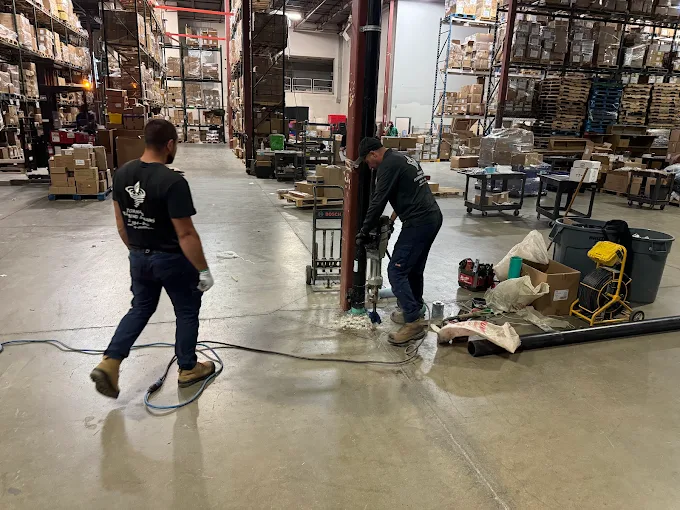 Commercial service crew working inside an industrial facility with large mechanical equipment
